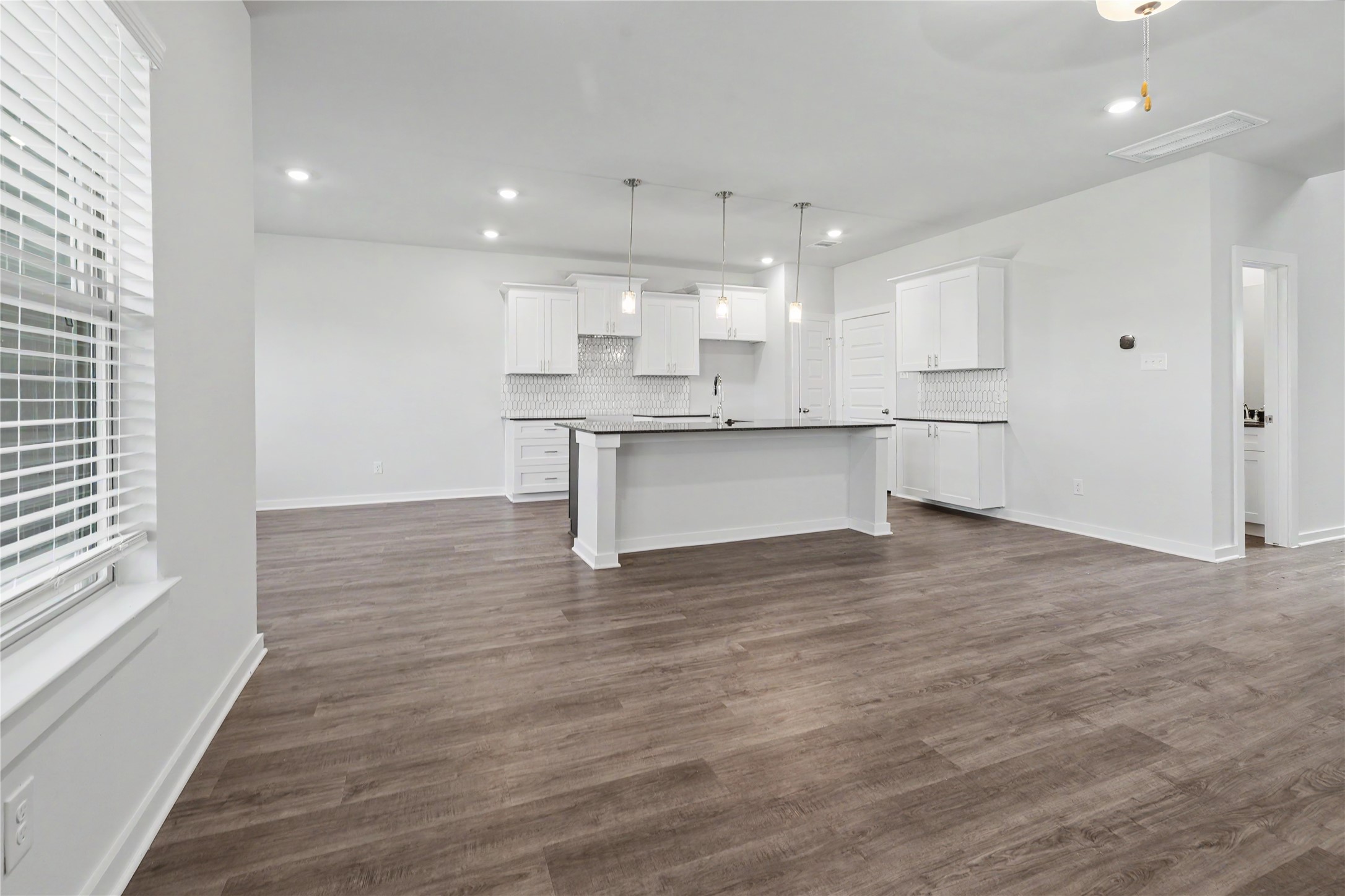 6426 Bolinas Court Rosharon, TX 77583 - Photo 21 of 49 a large white kitchen with kitchen island a sink wooden floor and a refrigerator