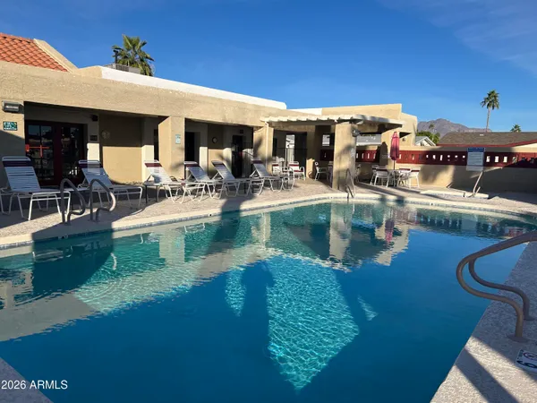 a view of a swimming pool with outdoor seating