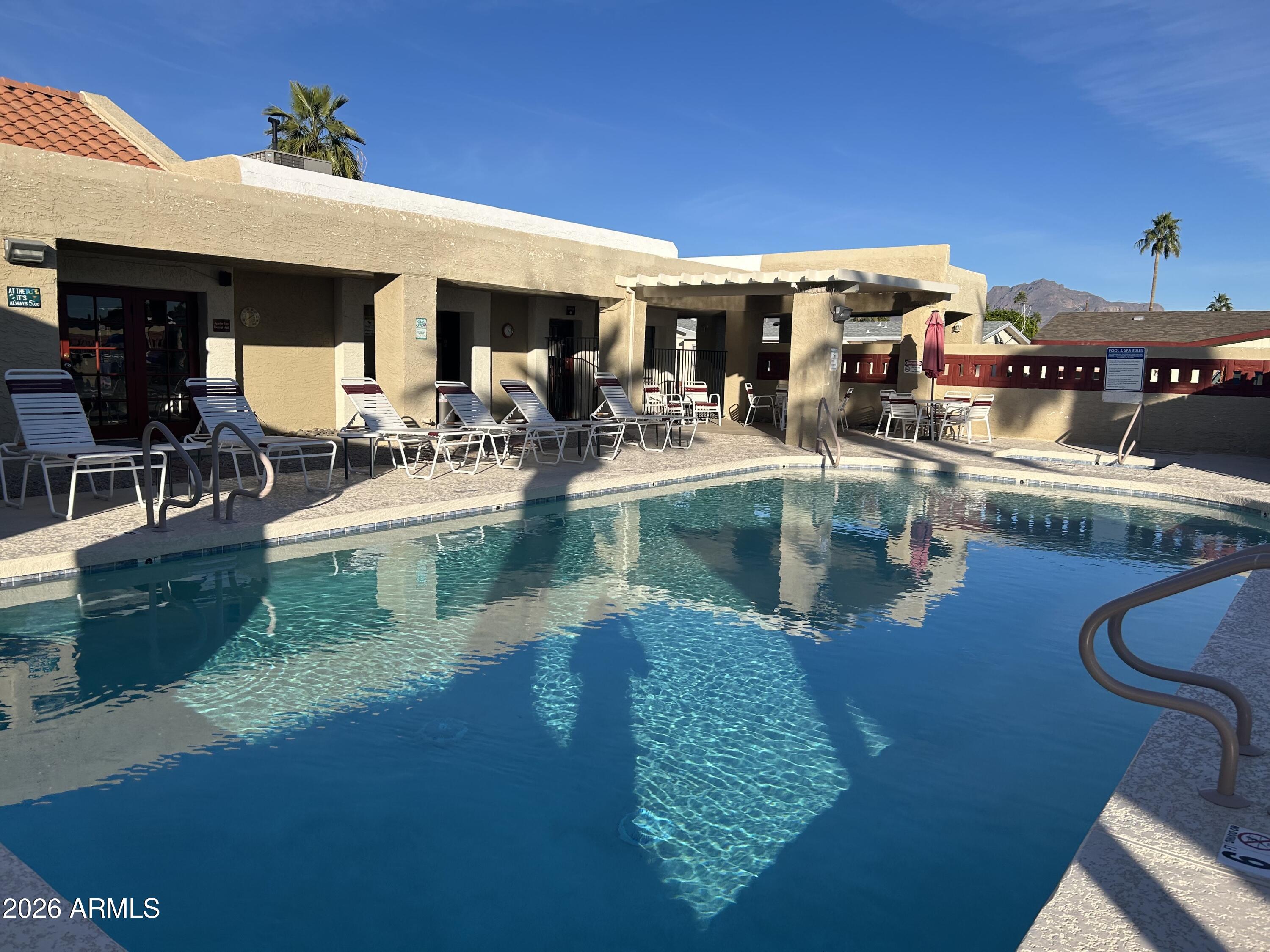 3500 South Tomahawk Road, Unit 217 Apache Junction, AZ 85119 - Photo 1 of 35 a view of a swimming pool with outdoor seating