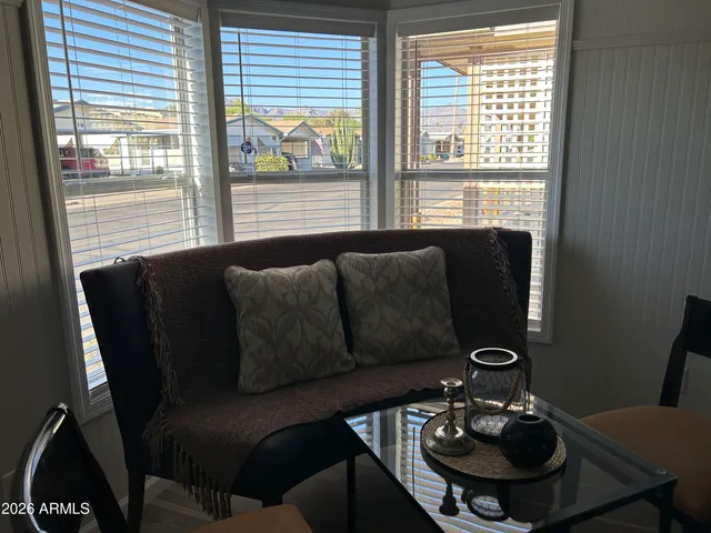 a view of a livingroom with furniture and a window