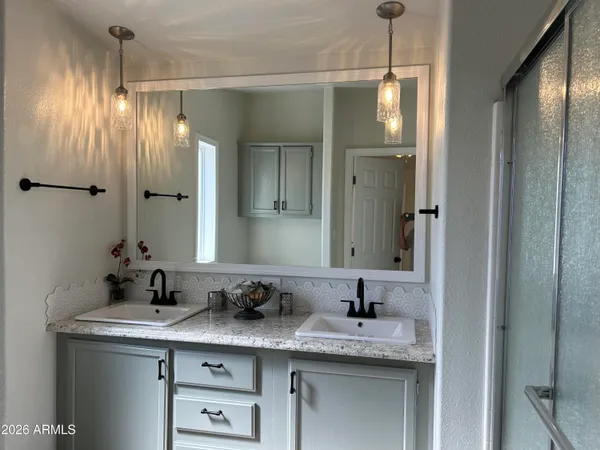 a bathroom with a granite countertop toilet sink and mirror