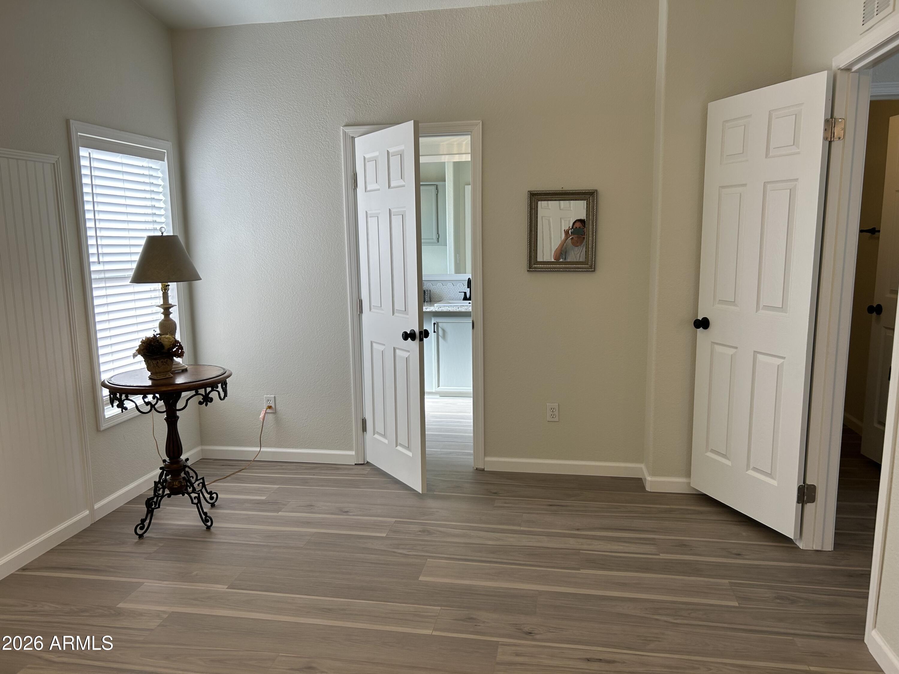 3500 South Tomahawk Road, Unit 217 Apache Junction, AZ 85119 - Photo 20 of 35 a view of a room with a hardwood floor and a ceiling fan