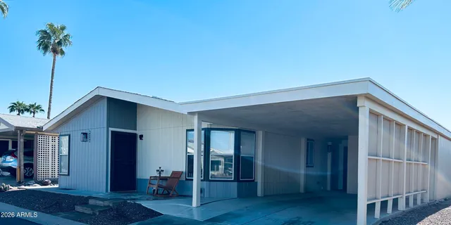 a kitchen with stainless steel appliances a table and chairs in it