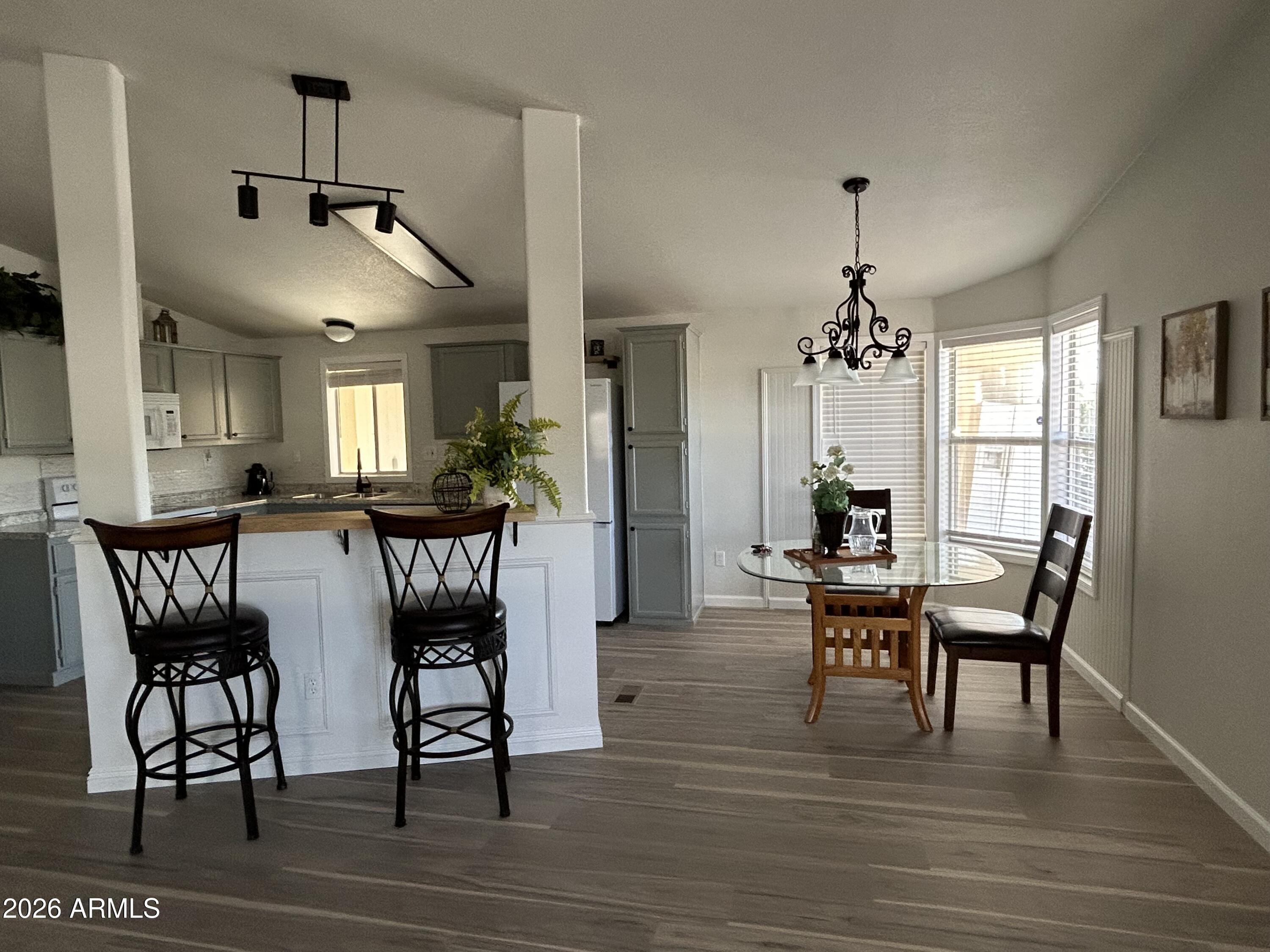 3500 South Tomahawk Road, Unit 217 Apache Junction, AZ 85119 - Photo 4 of 35 a view of a dining room with furniture window and wooden floor