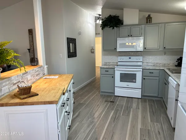 a kitchen with cabinets appliances a sink and a window