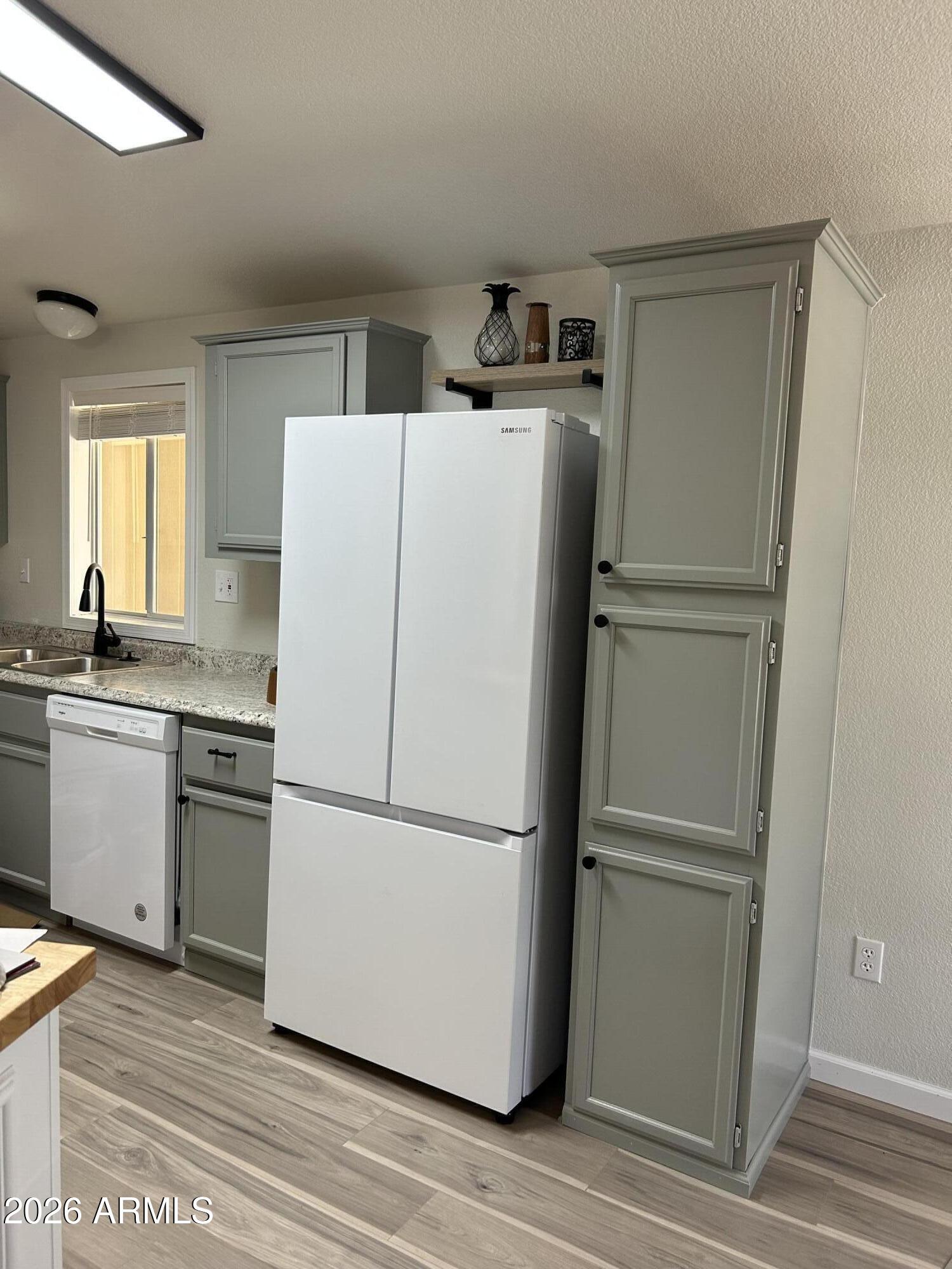 3500 South Tomahawk Road, Unit 217 Apache Junction, AZ 85119 - Photo 7 of 35 a white refrigerator freezer and a stove sitting inside of a kitchen