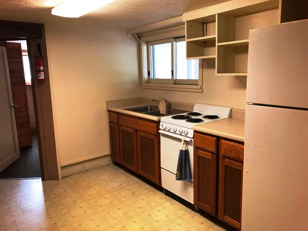a kitchen with stainless steel appliances granite countertop a stove a refrigerator and a refrigerator