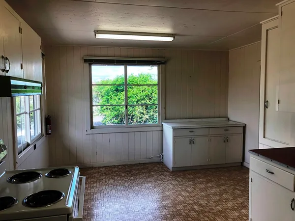 a kitchen with a stove and a window