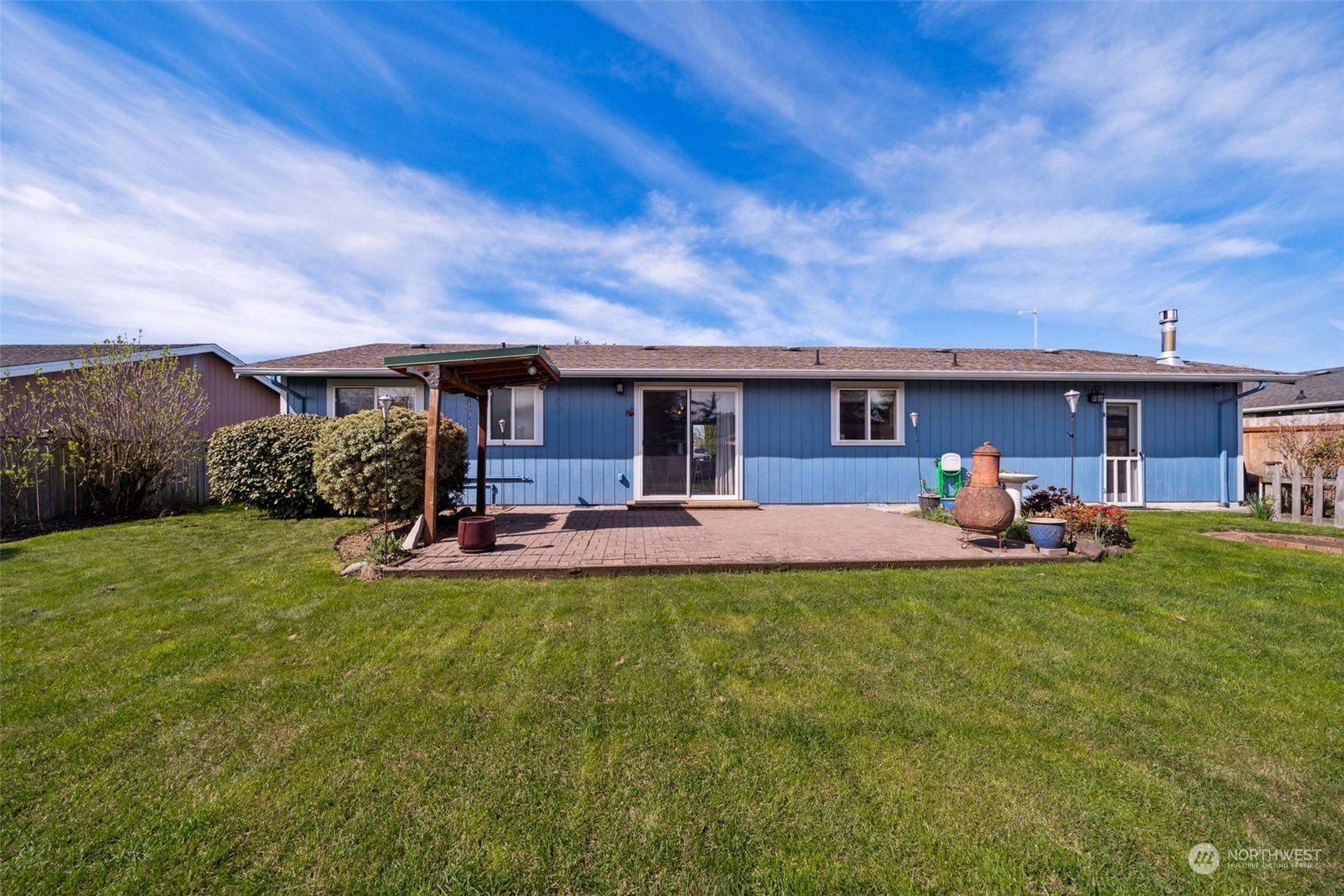 509 Harmony Lane Enumclaw, WA 98022 - Photo 17 of 22 a view of a house with a patio and a yard