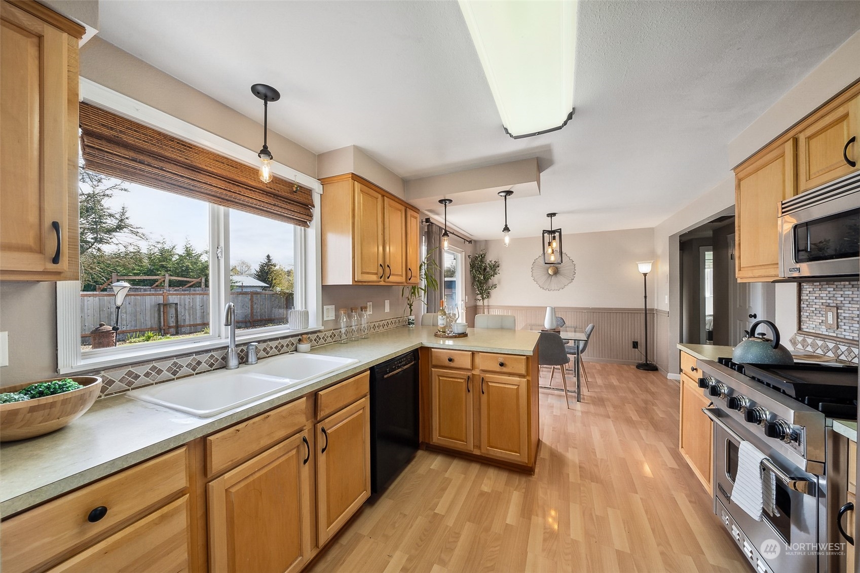 509 Harmony Lane Enumclaw, WA 98022 - Photo 6 of 22 a kitchen with stainless steel appliances granite countertop a sink stove and wooden floor