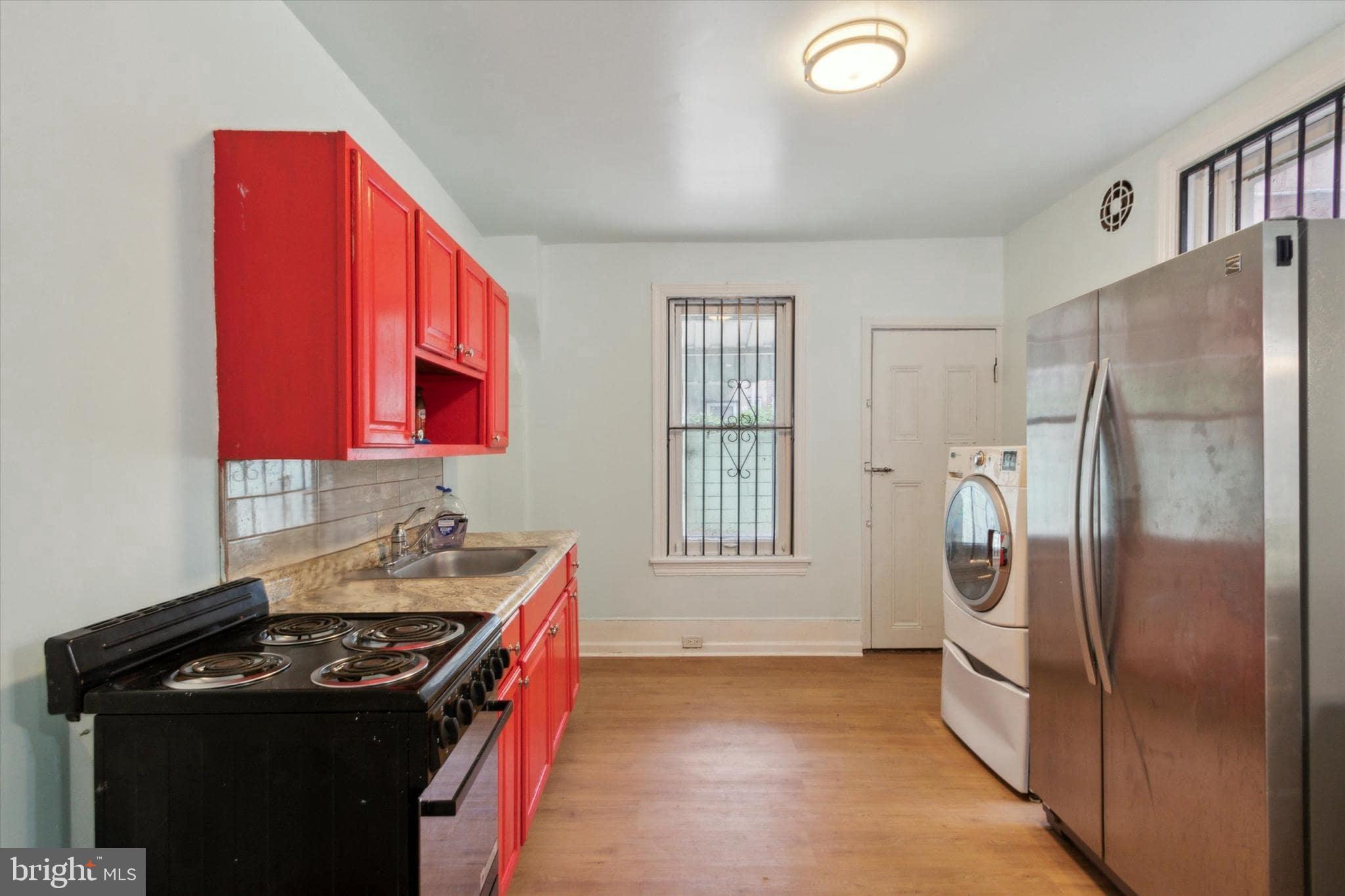 1933 Page Street Philadelphia, PA 19121 - Photo 6 of 19 a kitchen with stainless steel appliances granite countertop a refrigerator a sink and a stove