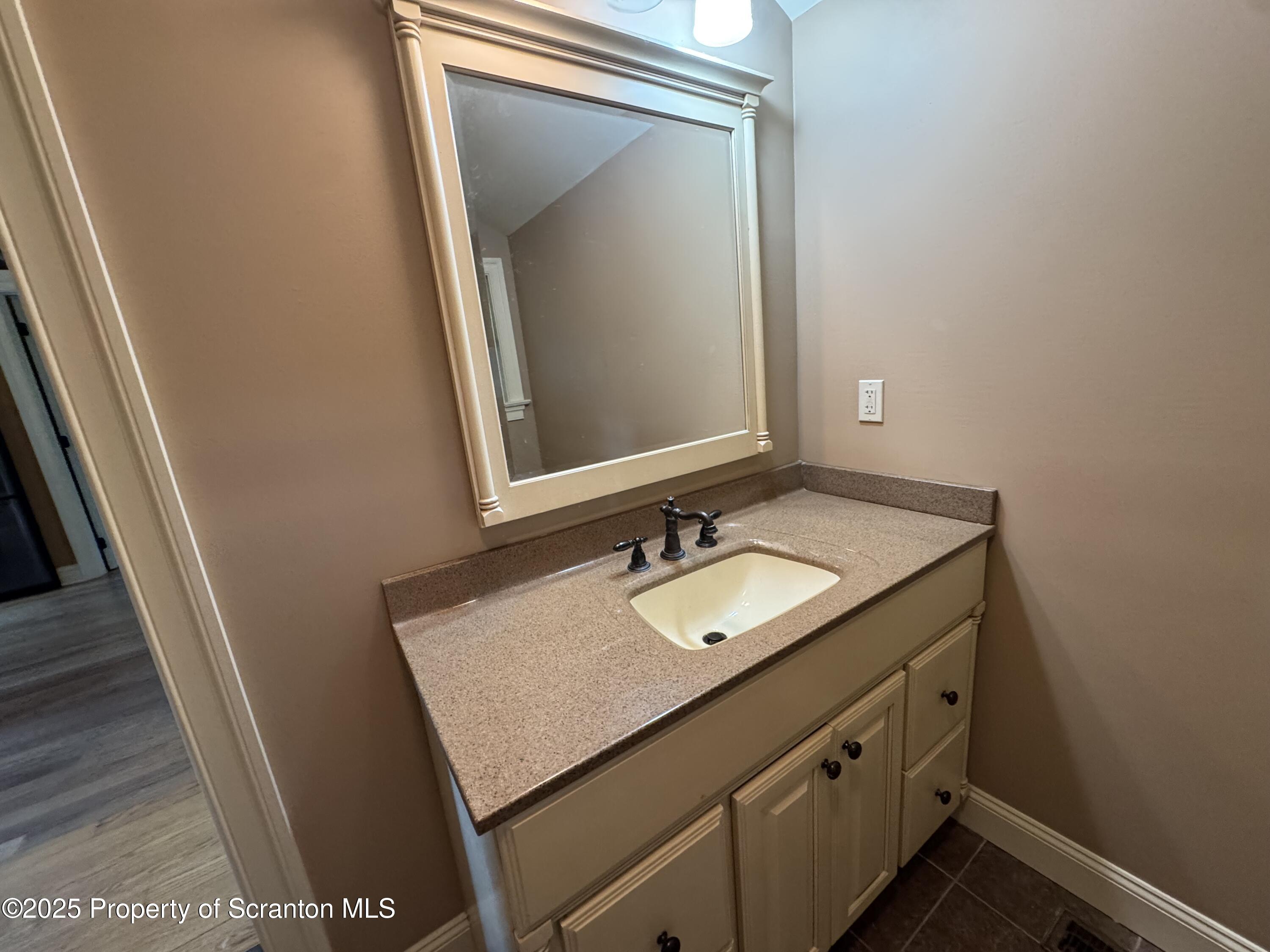 131 Ball Pond Road Thompson, PA 18465 - Photo 11 of 21 a bathroom with a sink a mirror and vanity