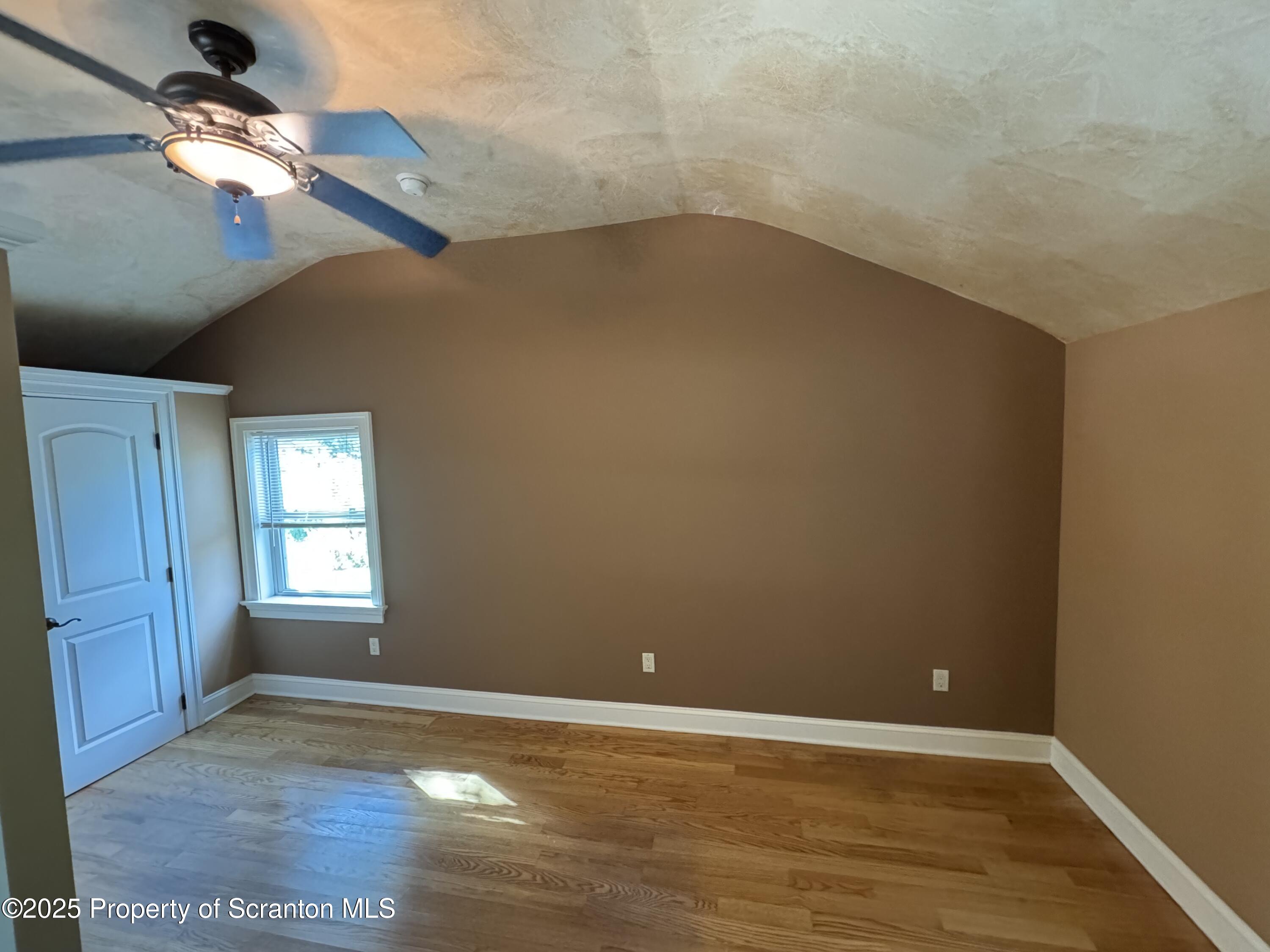 131 Ball Pond Road Thompson, PA 18465 - Photo 15 of 21 an empty room with a window and ceiling fan