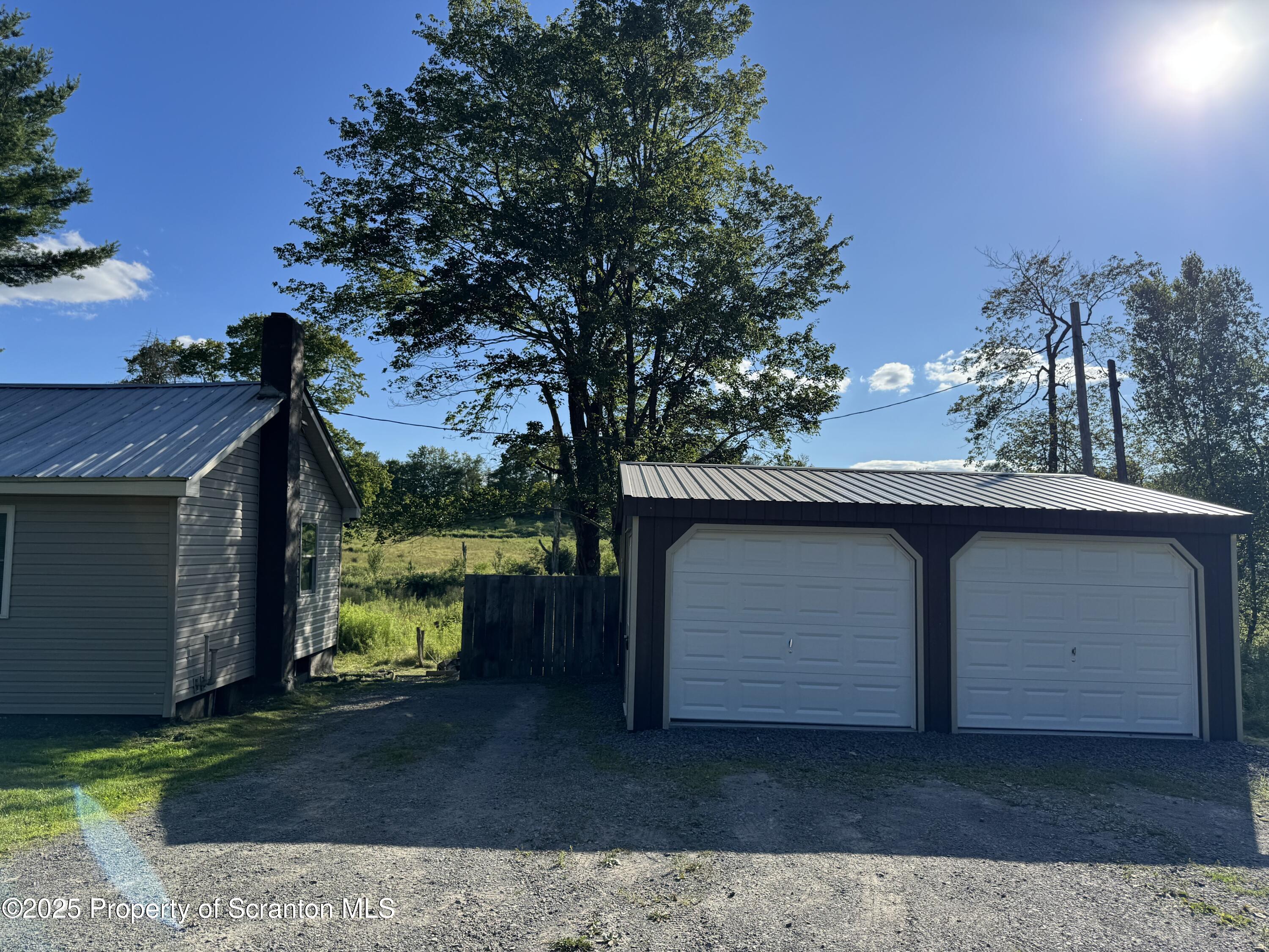 131 Ball Pond Road Thompson, PA 18465 - Photo 18 of 21 a front view of a house with a yard
