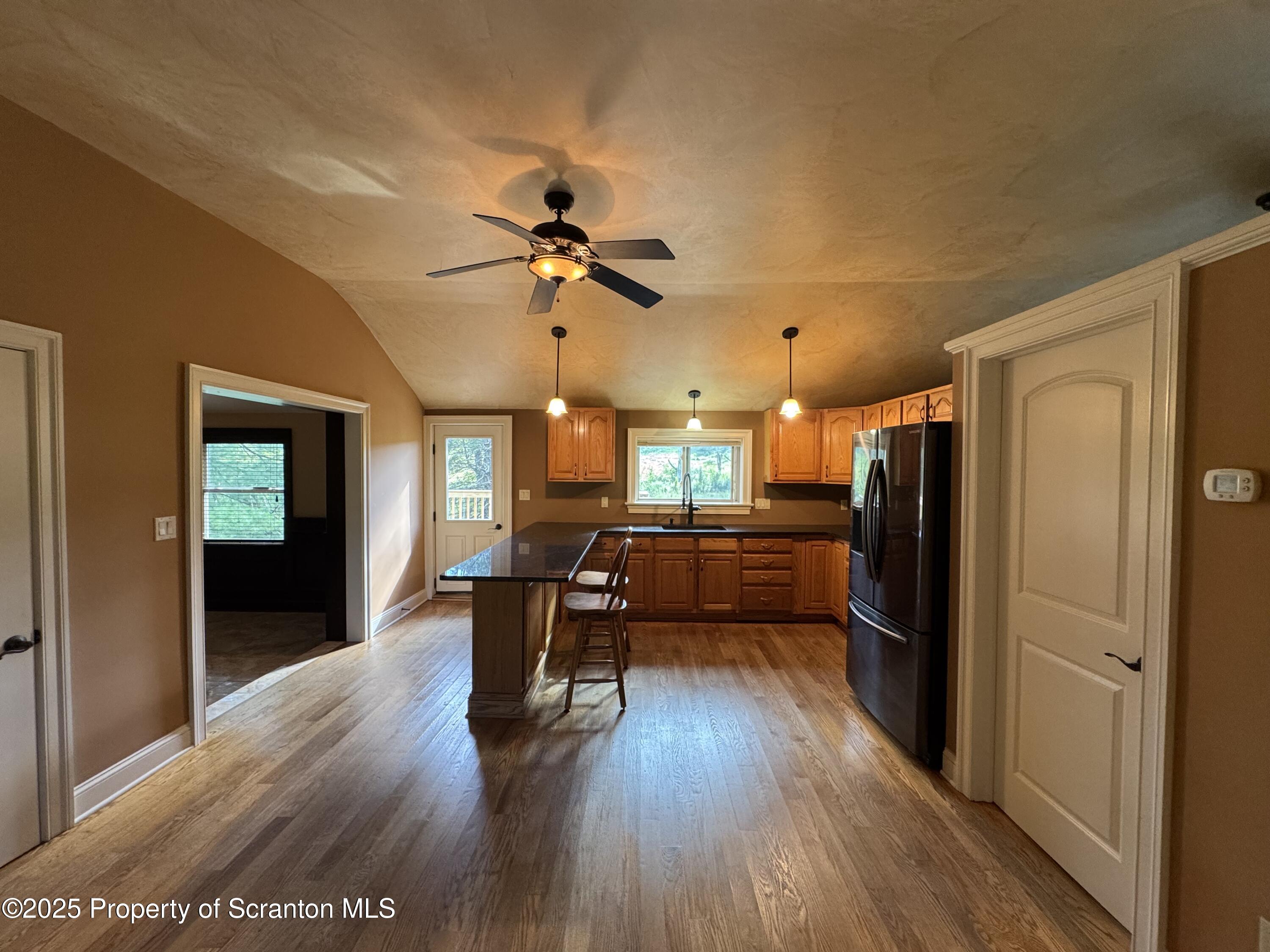 131 Ball Pond Road Thompson, PA 18465 - Photo 4 of 21 a view of a livingroom with furniture a ceiling fan and wooden floor