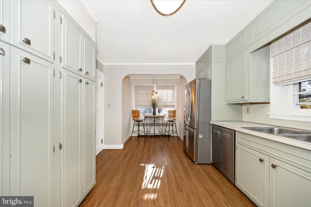 a view of a kitchen with a dishwasher cabinets and a wooden floor