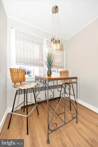 a dining room with furniture and wooden floor