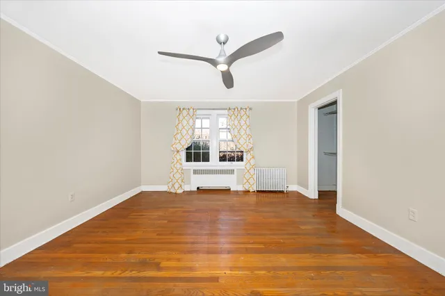 a view of a livingroom with wooden floor and white walls