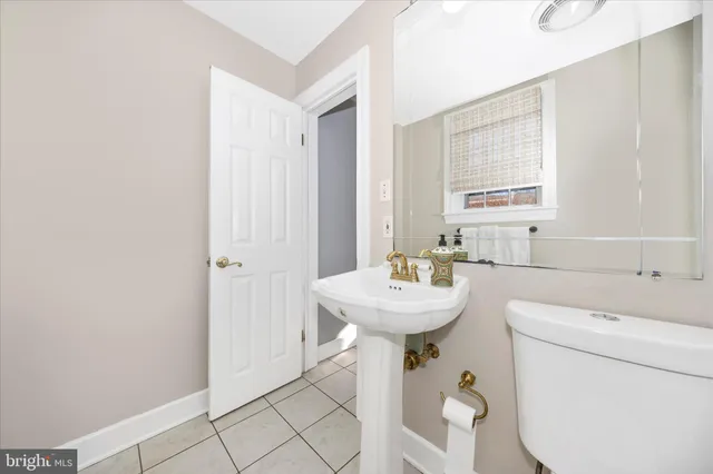 a bathroom with a sink a toilet and mirror