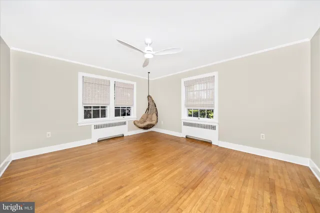a view of a livingroom with wooden floor and a window