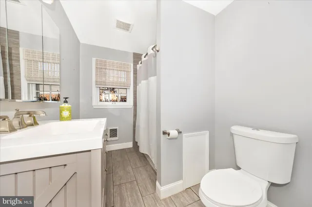 a bathroom with a sink a toilet tub and shower