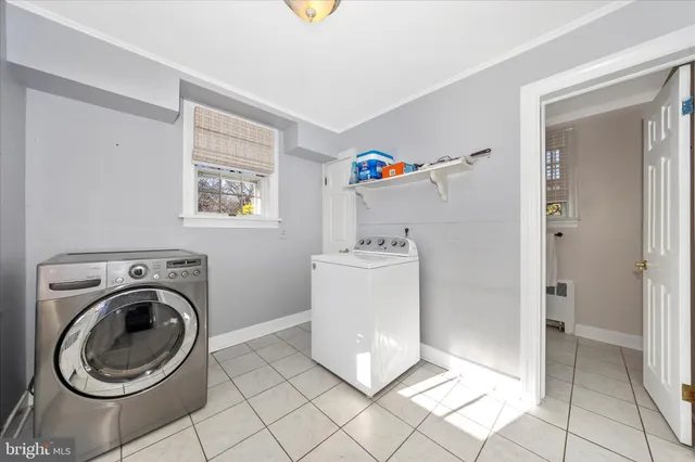 a utility room with cabinets washer and dryer
