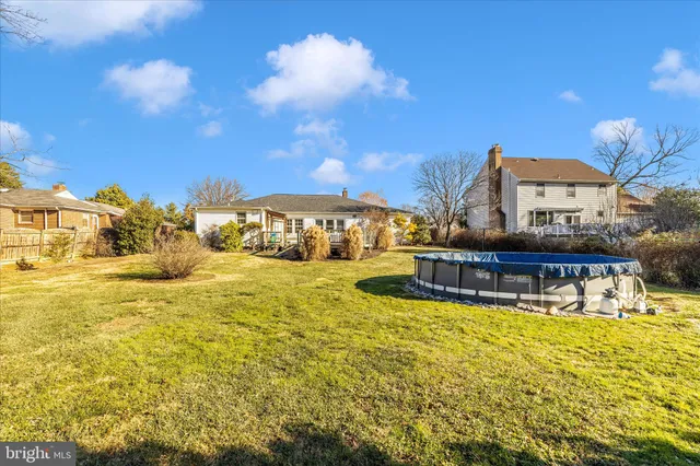 a swimming pool with outdoor seating and yard