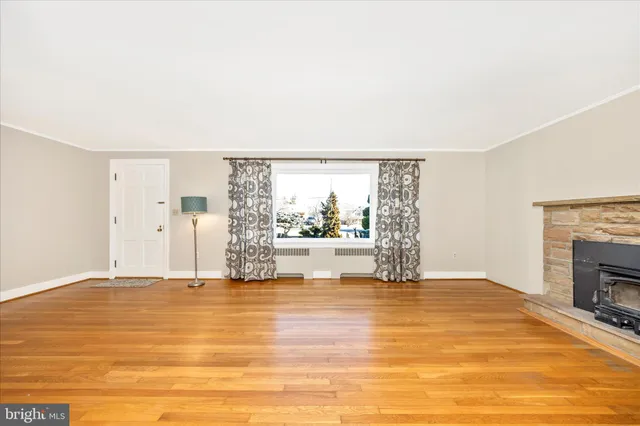 a view of an empty room with a fireplace