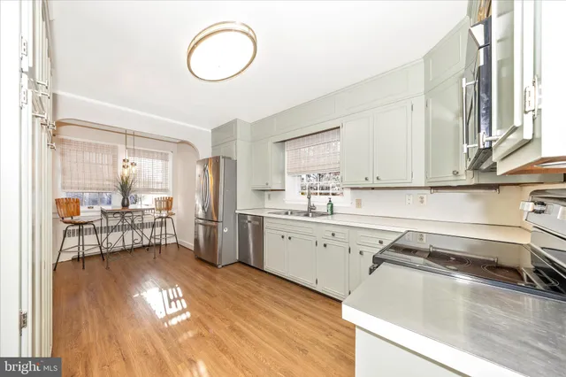 a kitchen with a sink cabinets and window