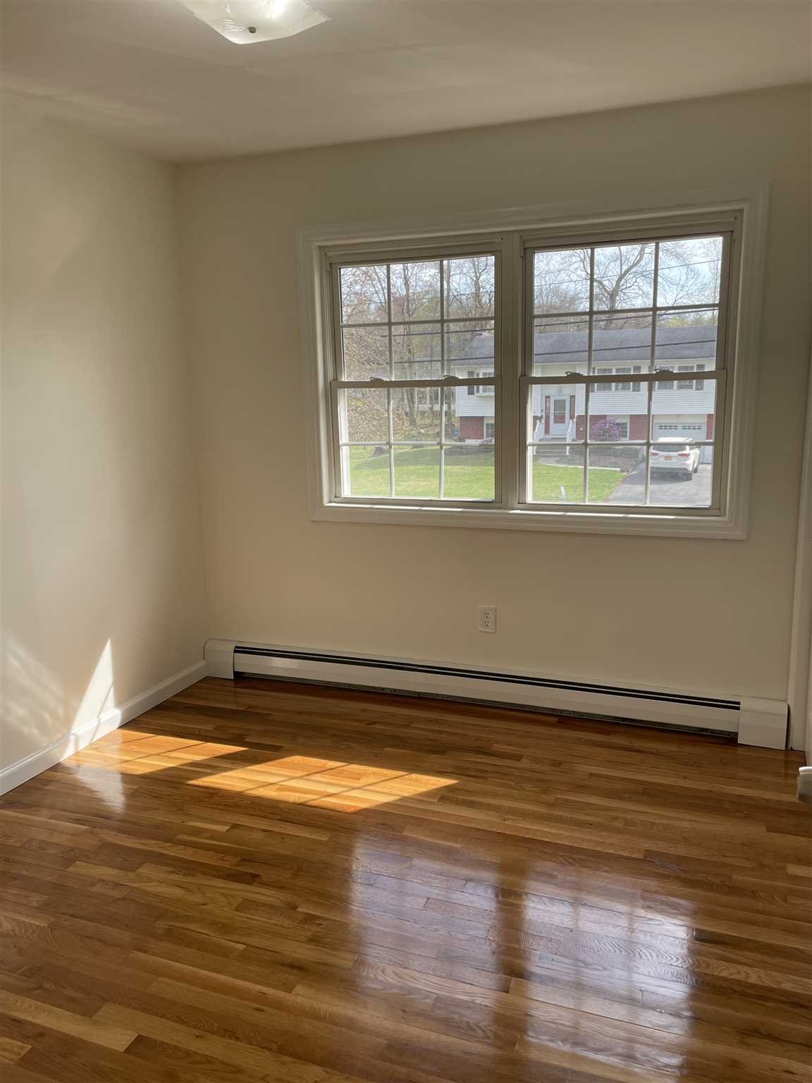 36 Sutton Park Road Poughkeepsie, NY 12603 - Photo 13 of 17 a view of empty room with window and wooden floor
