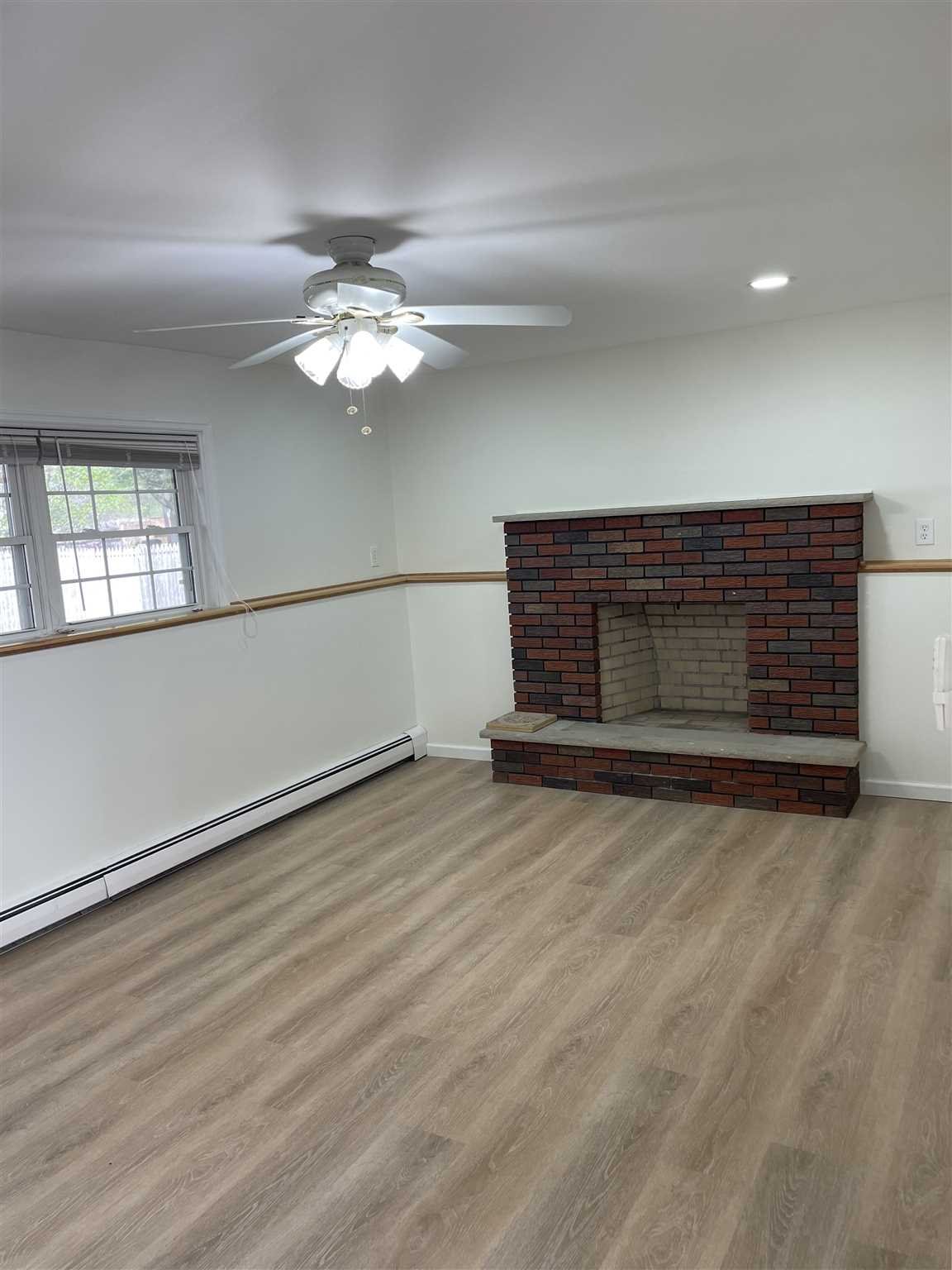36 Sutton Park Road Poughkeepsie, NY 12603 - Photo 14 of 17 wooden floor in an empty room with a window