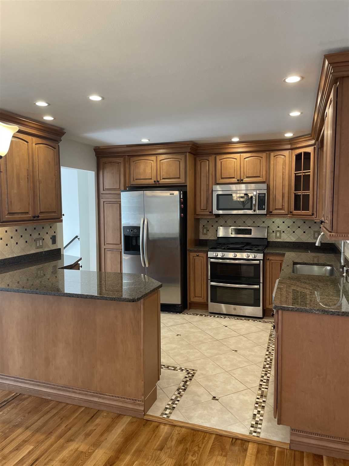 36 Sutton Park Road Poughkeepsie, NY 12603 - Photo 2 of 17 a kitchen with stainless steel appliances granite countertop a refrigerator and a stove