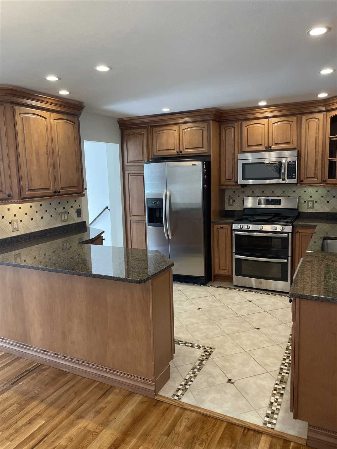 36 Sutton Park Road Poughkeepsie, NY 12603 - Photo 3 of 17 a kitchen with stainless steel appliances granite countertop a refrigerator a stove and a sink