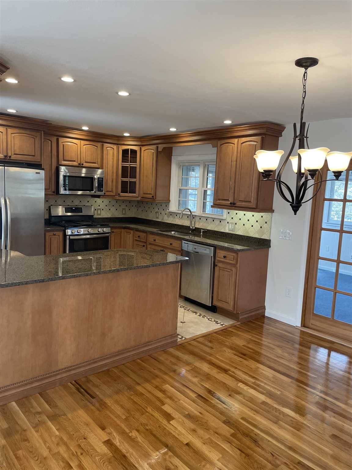 36 Sutton Park Road Poughkeepsie, NY 12603 - Photo 4 of 17 a kitchen with stainless steel appliances granite countertop a sink and a stove