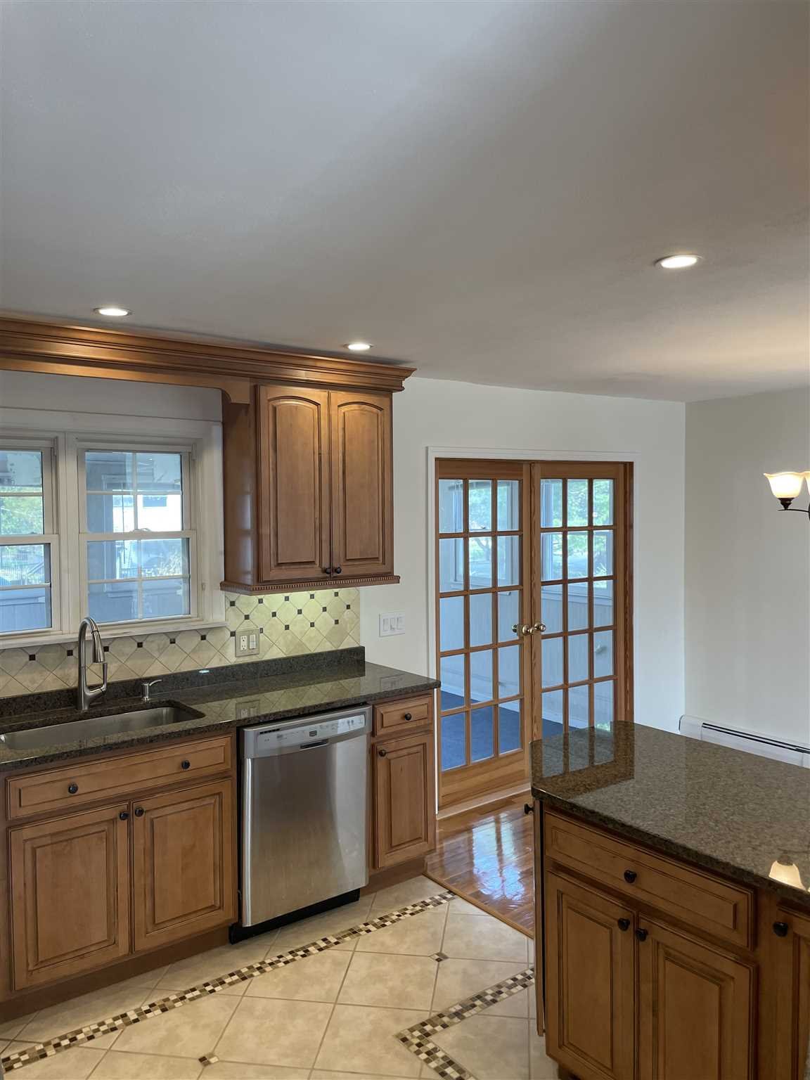 36 Sutton Park Road Poughkeepsie, NY 12603 - Photo 5 of 17 a kitchen with stainless steel appliances granite countertop a sink and cabinets