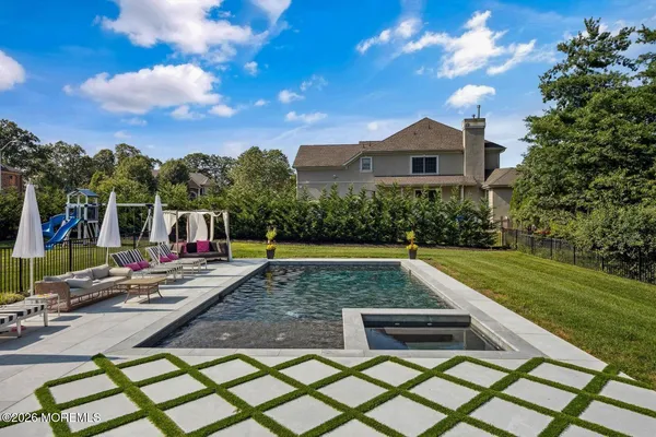 a view of a house with pool and a yard