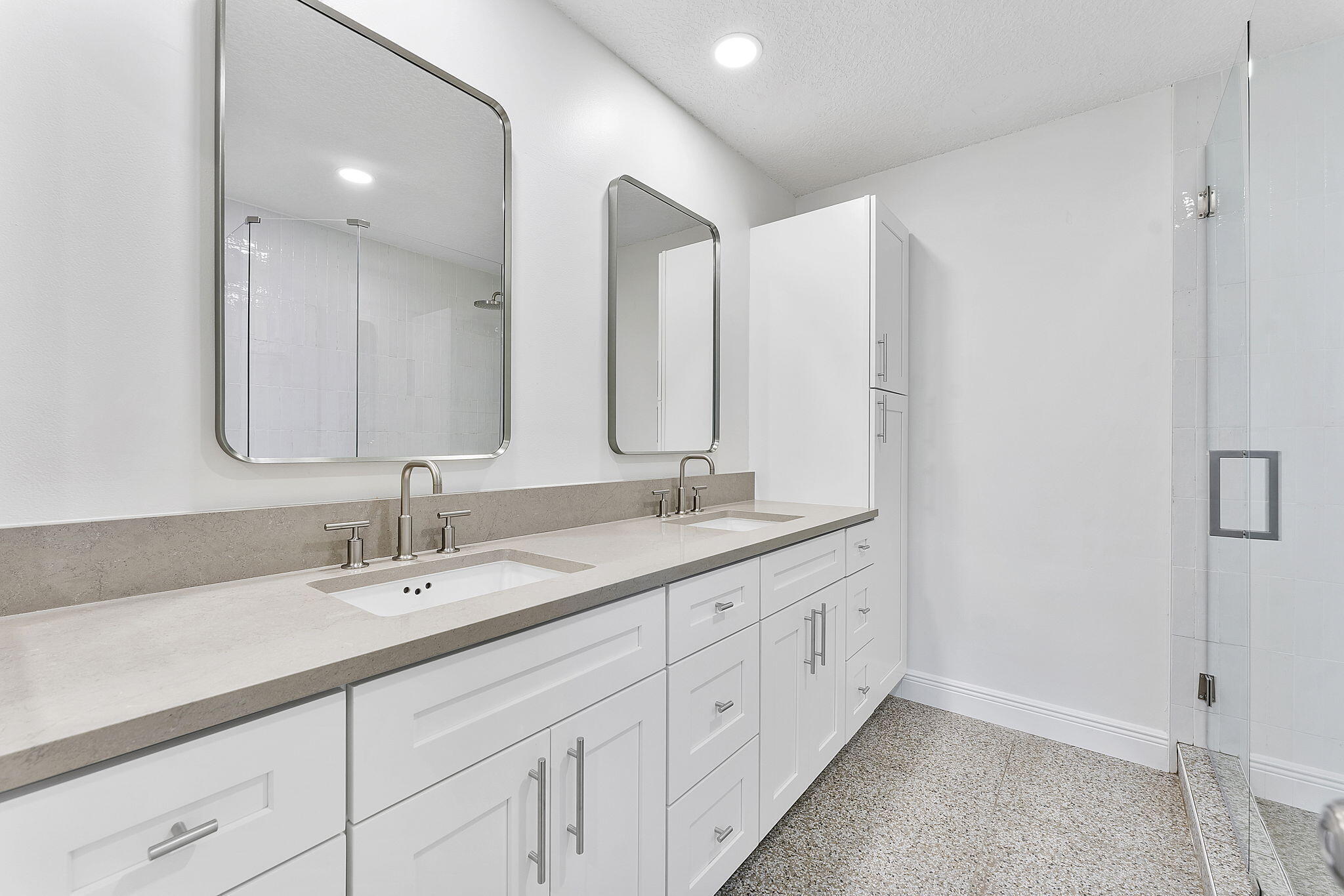 9180 Pine Springs Drive Boca Raton, FL 33428 - Photo 16 of 29 a bathroom with double sink and a mirror
