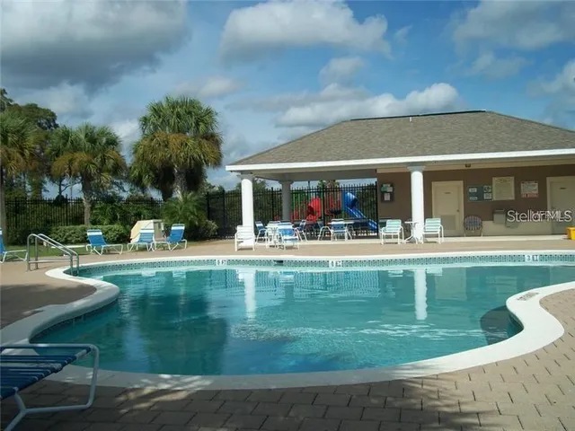a view of a swimming pool with outdoor seating