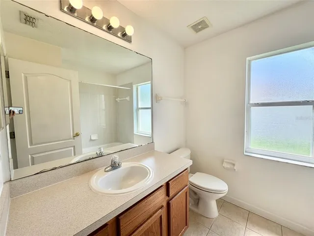 a bathroom with a sink toilet and vanity