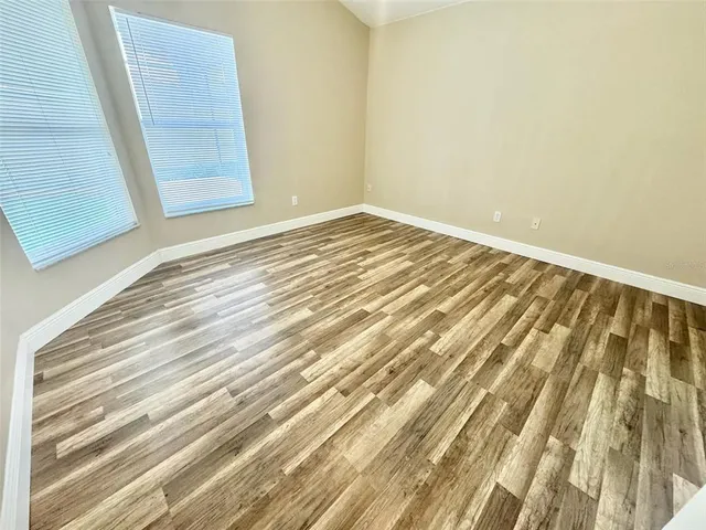 a view of wooden floor and brick walls