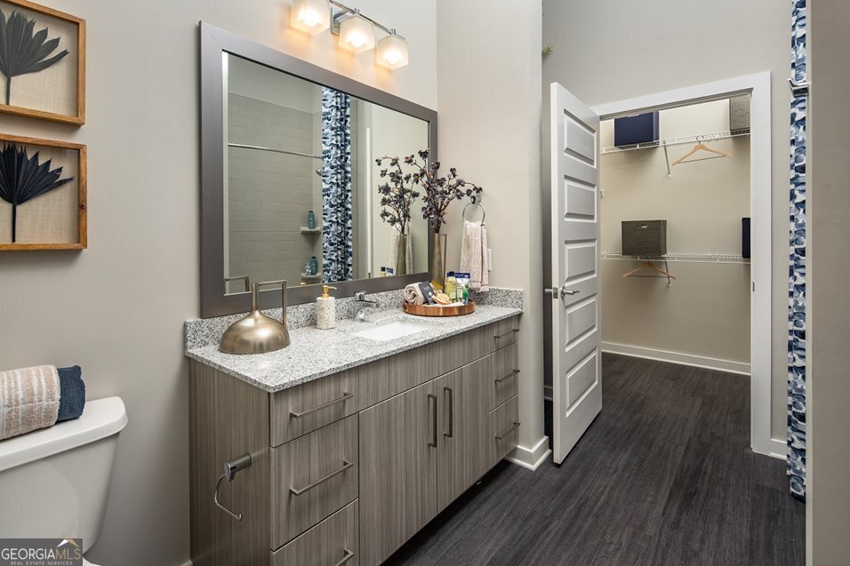 1399 Herrington Road, Unit 1202 Lawrenceville, GA 30044 - Photo 11 of 32 a bathroom with a sink and a mirror