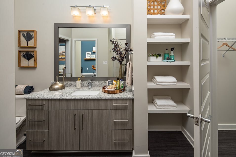 1399 Herrington Road, Unit 1202 Lawrenceville, GA 30044 - Photo 12 of 32 a bathroom with a granite countertop sink and a mirror