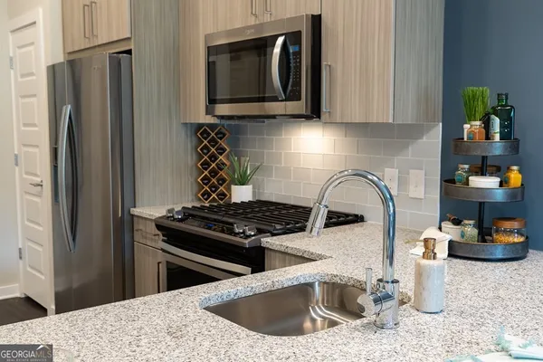 a kitchen with a sink stove and refrigerator