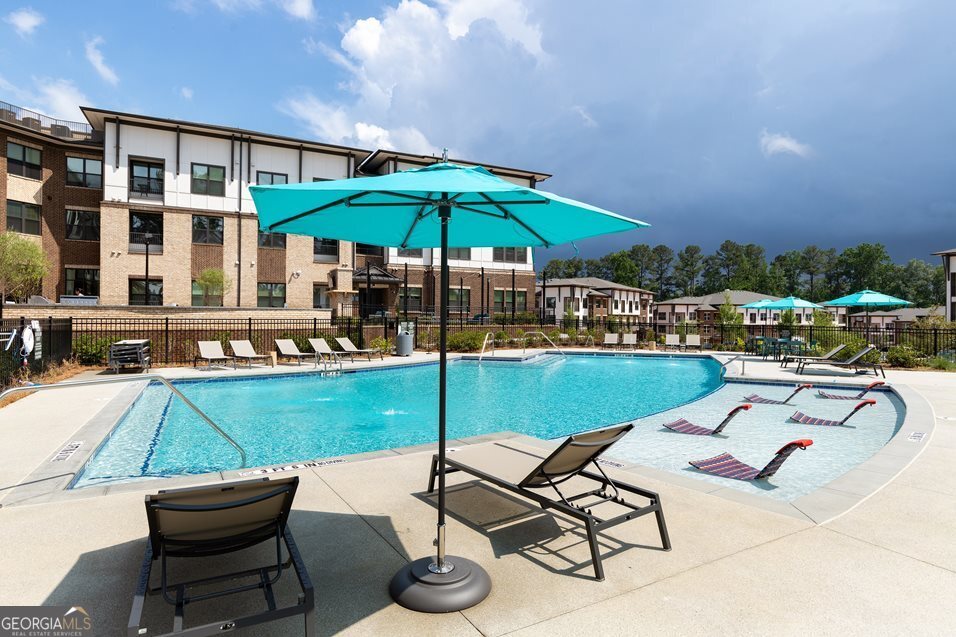 1399 Herrington Road, Unit 1202 Lawrenceville, GA 30044 - Photo 28 of 32 a table and chairs in the patio