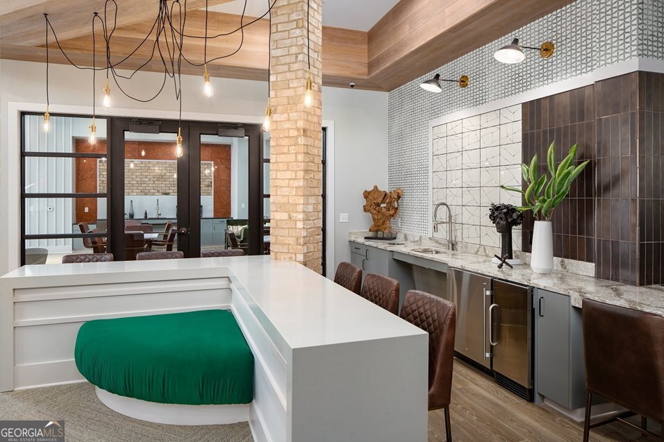 1399 Herrington Road, Unit 1202 Lawrenceville, GA 30044 - Photo 32 of 32 a kitchen with a table chairs and white cabinets