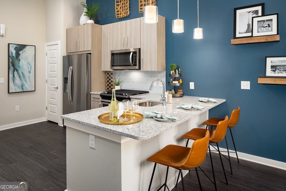 1399 Herrington Road, Unit 1202 Lawrenceville, GA 30044 - Photo 4 of 32 a dining room with furniture and wooden floor
