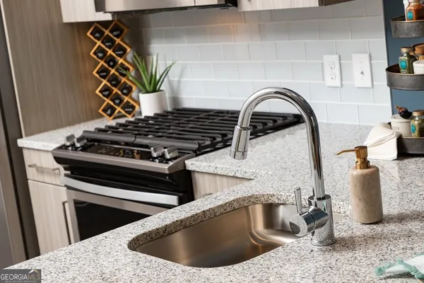 a kitchen with a stove and a sink