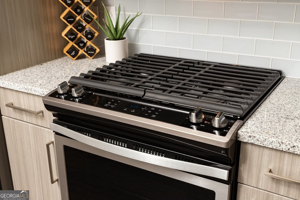 1399 Herrington Road, Unit 1202 Lawrenceville, GA 30044 - Photo 6 of 32 a close view of a stove top oven and glass door