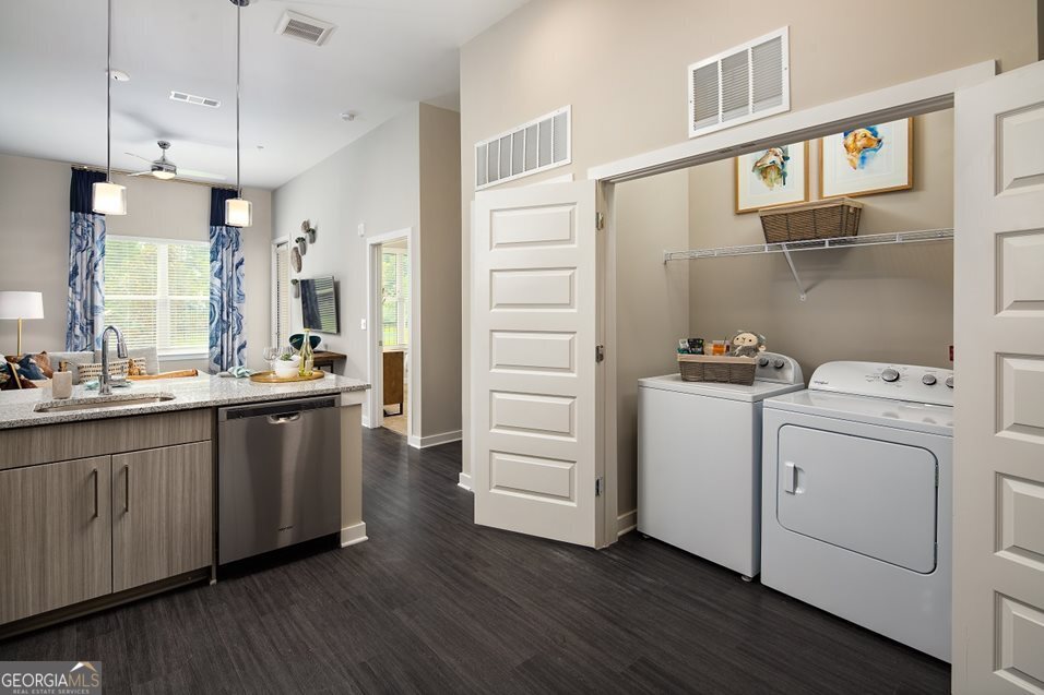 1399 Herrington Road, Unit 1202 Lawrenceville, GA 30044 - Photo 7 of 32 a bathroom with a double vanity sink and a mirror