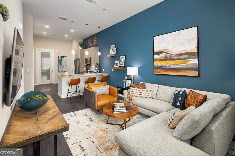 1399 Herrington Road, Unit 1202 Lawrenceville, GA 30044 - Photo 8 of 32 a living room with furniture and a rug